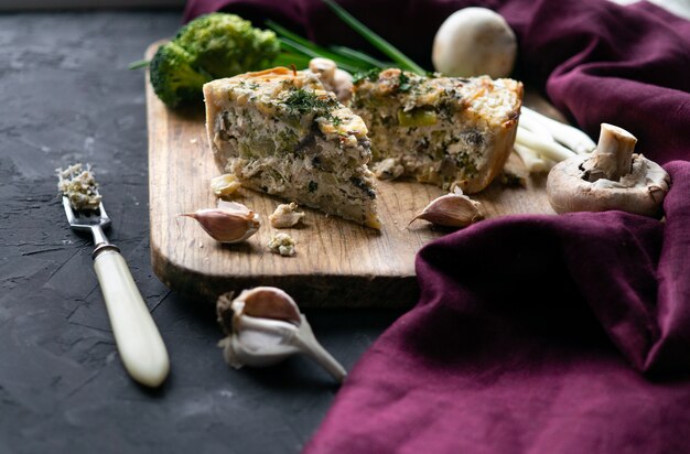 Pie on a wooden surface with cutlery