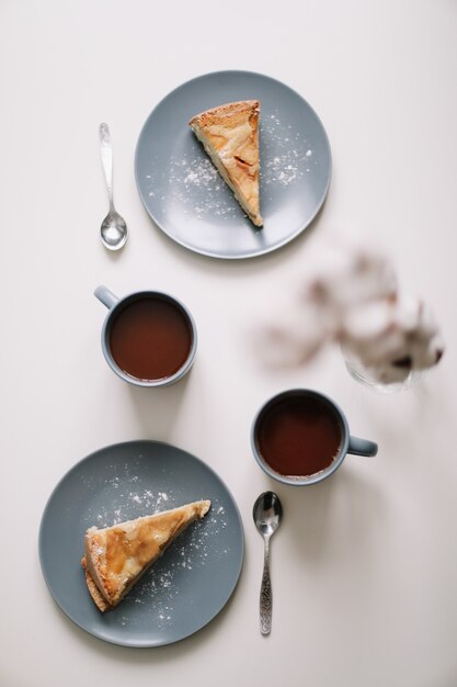 Piece of apple pie on plate with cup of coffee