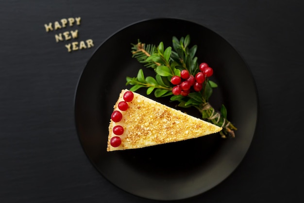 Piece of cake decorated with the inscription happy new year