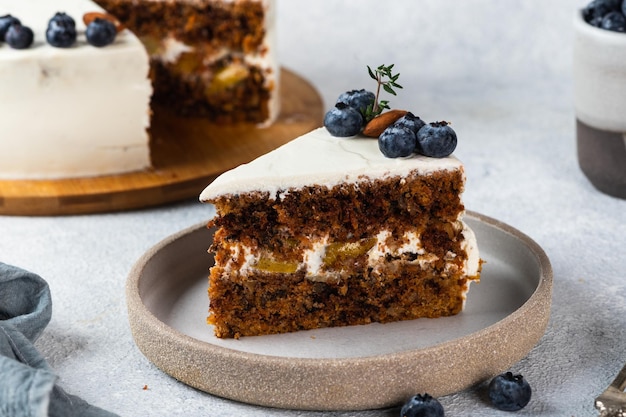 Piece of carrot cake with walnuts and blueberry on dark background. Local food. Traditional american cake. Cake for thanksgiving day. Christmas cake.