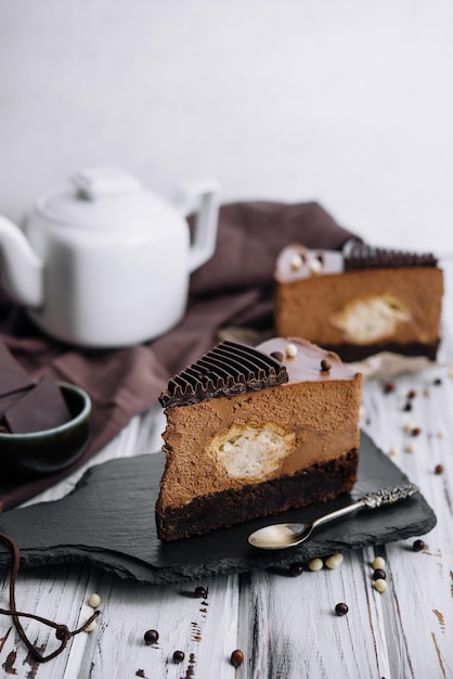 A piece of chocolate cake with tea