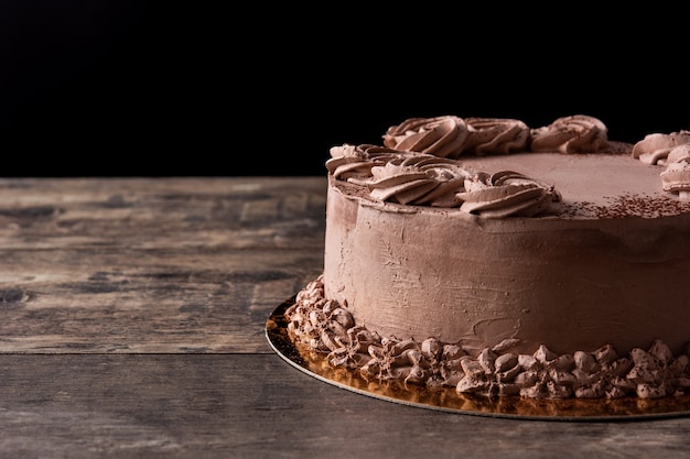 Piece of chocolate truffle cake on wooden table