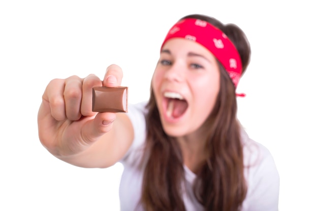 Piece of chocolate in woman's hand isolated