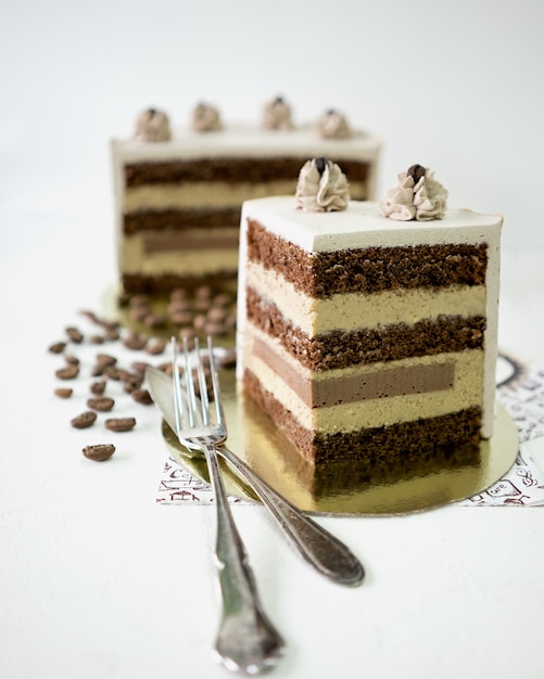 A piece of coffee cake on white background and vintage fork