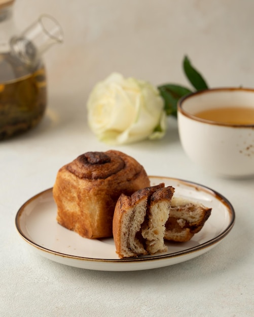 Piece of the cruffin and cup of tea white roses