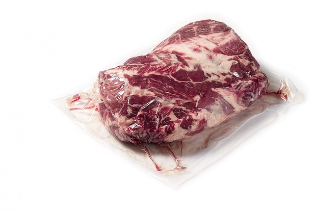 Piece of Fresh pork meat in vacuum packed. Vacuum packed raw fresh pork neck meat isolated