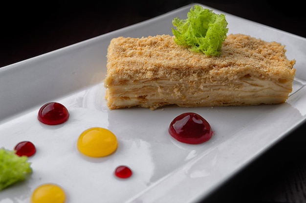 A piece of Napoleon cake dessert on a plate selective focus