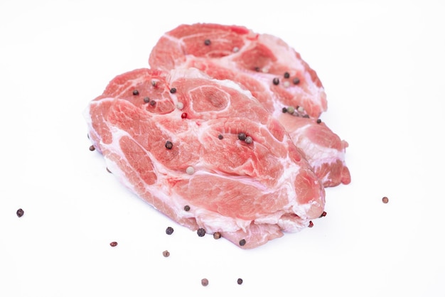 A piece of raw pork meat on a white background