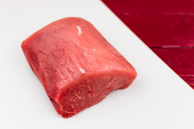 A piece of raw pork on a white background