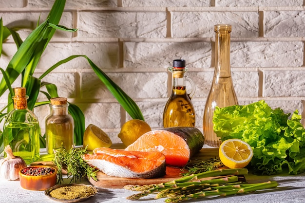 Piece of raw salmon fish with spices and herbs