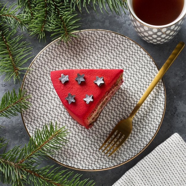 A piece of Red Cake and a cup of tea on grey background Cristmas decoration