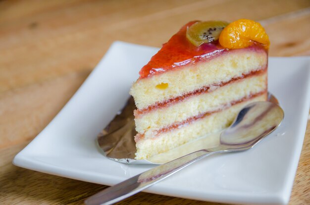 Piece of stawberry cake on white plate 