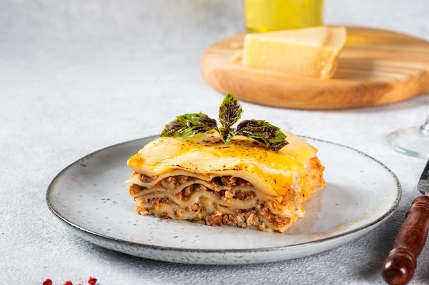 Piece of tasty hot lasagna on light background Traditional italian lasagna Italian food Close up lasagna Bolognese sauce Bechamel sauce Still life of food Homemade meat lasagna