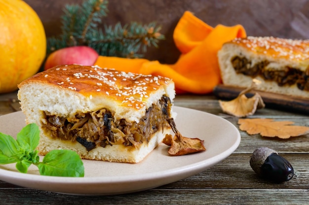 piece of tasty pie with cabbage and forest mushrooms