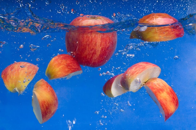 pieces of apple floating in the water