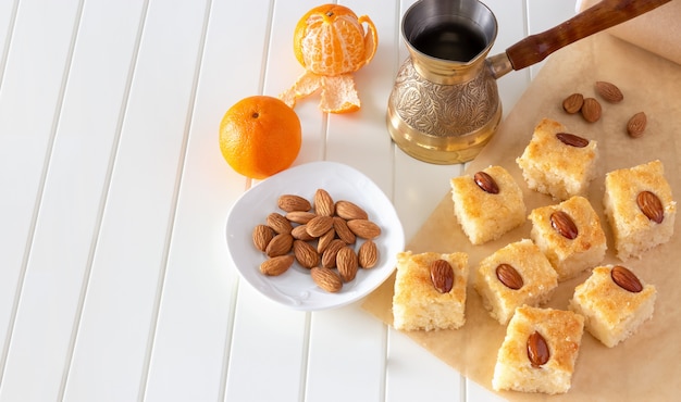 Pieces Basbousa traditional Arabic semolina cake with almond.