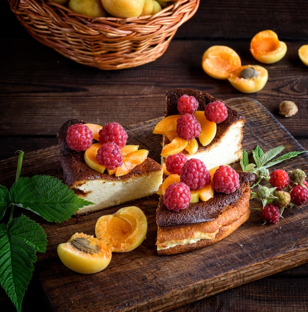 Pieces of cottage cheese pie with strawberries and apricots 