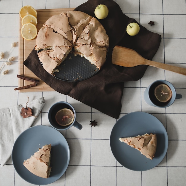 Pieces of delicious apple pie Composition with tasty homemade apple pie cinnamon and apples on table Flat lay Top view