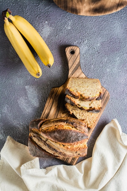 Pieces of fresh banana bread on a cutting board Social media food Top and vertical view