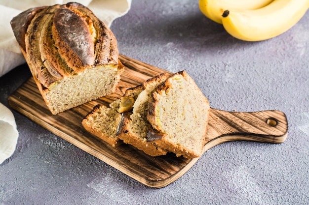 Pieces of fresh banana bread on a cutting board on the table Social media food