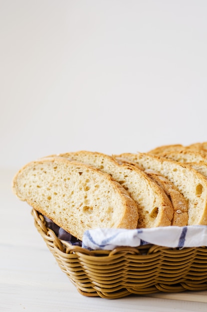 Pieces of fresh homemade bread on a white towel in basket