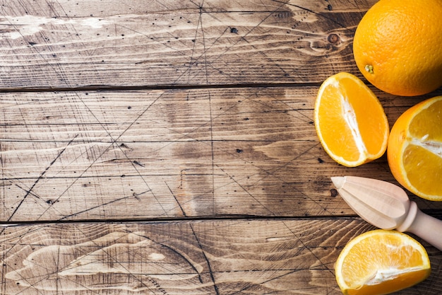 Pieces of fresh orange juice on wooden table.