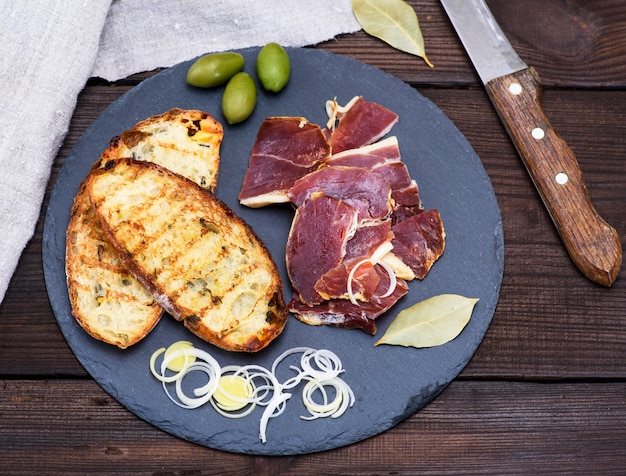 Pieces of jamon and white fried bread for a sandwich 