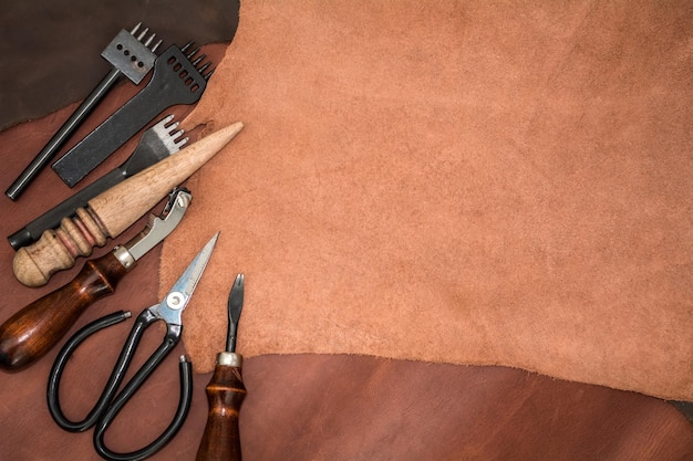 Pieces of leather and working tools Craftman's workspace