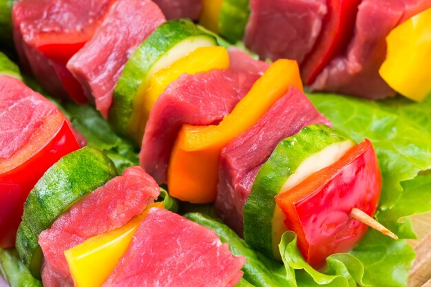 Pieces of meat with vegetables on salad leaves