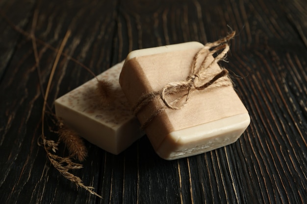 Pieces of natural handmade soap on wooden background