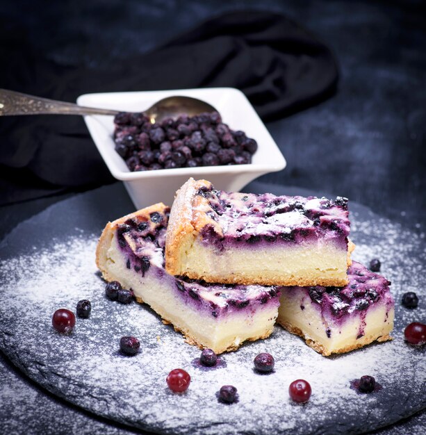 Pieces of pie from cottage cheese and blueberries 