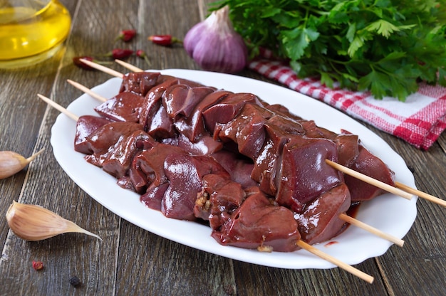 Pieces of raw pork liver on wooden skewers for cooking barbecue Diet dish Asian cuisine