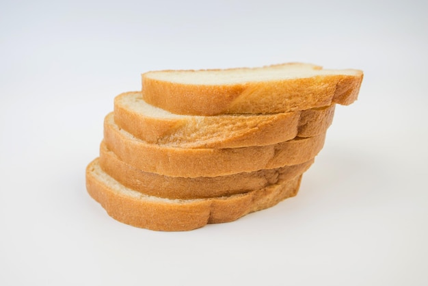 Pieces of sliced loaf on a white background Several slices of white bread