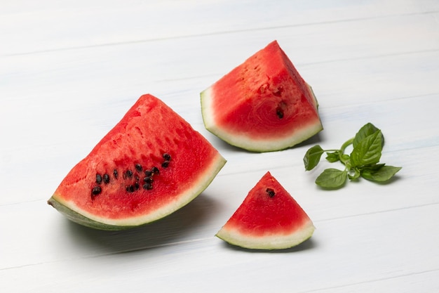 Pieces of watermelon and a sprig of basil