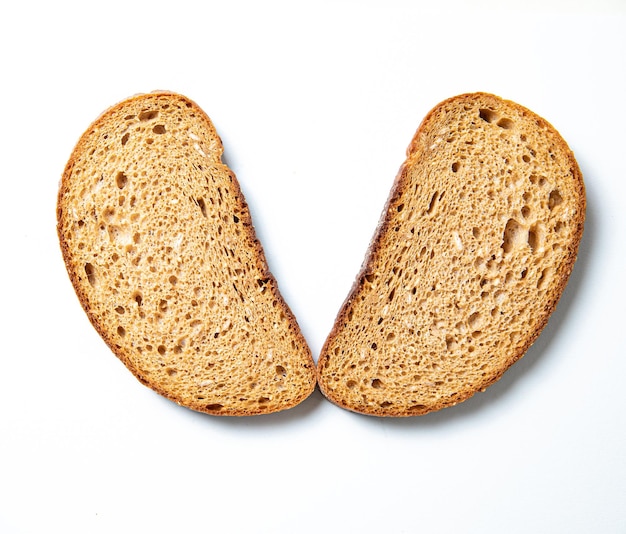 Pieces of white bread on a white plate slicedxA