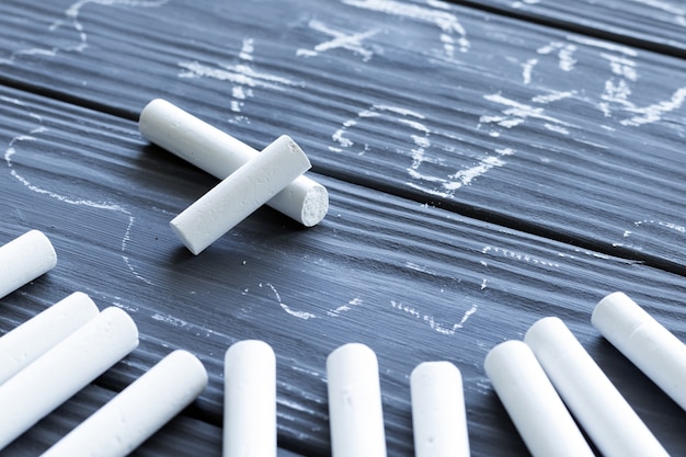 Pieces of white chalk on the table close up