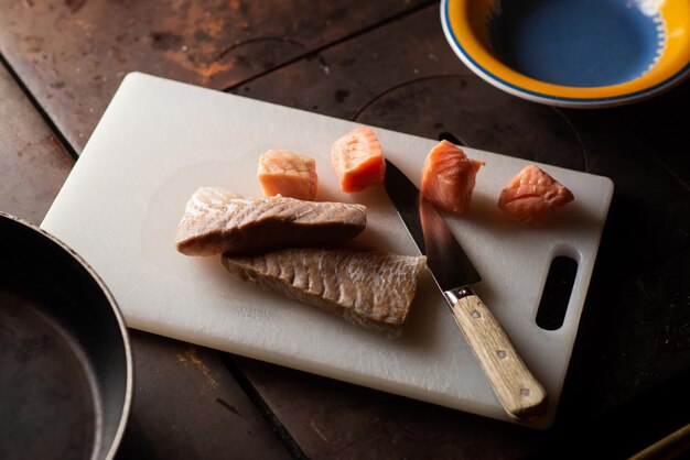 Pieces of white and red fish on a cutting board Preparation for cooking