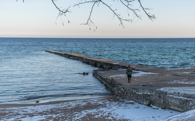 Pier on the beach in winter day