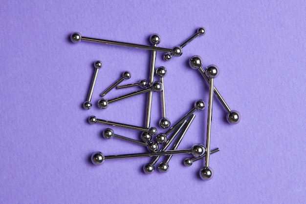 Piercing earrings closeup on a violet background