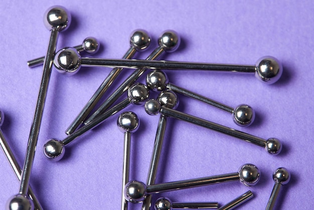 Piercing earrings closeup on a violet background