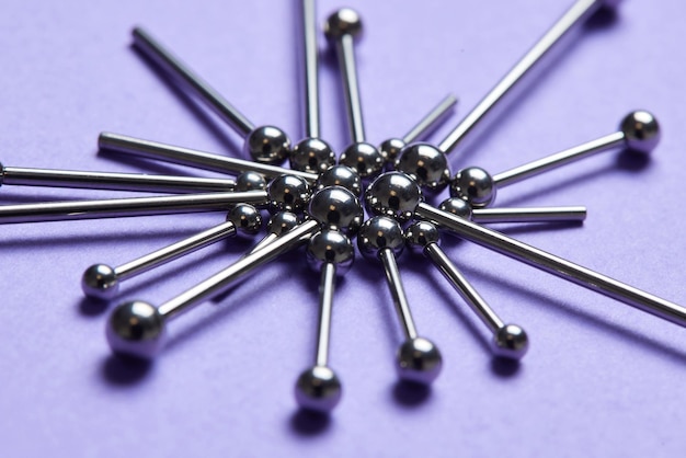 Piercing earrings closeup on a violet background