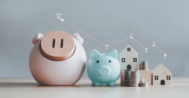 Pig piggy bank and stacked coins with yearly graph on gray background. wooden house design Financial