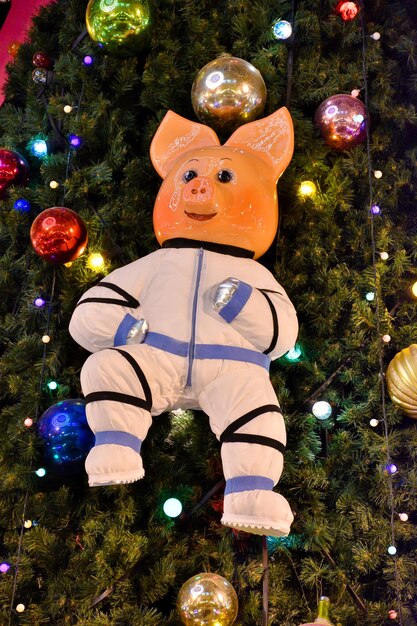 Pig in spacesuit hanging on Christmas tree