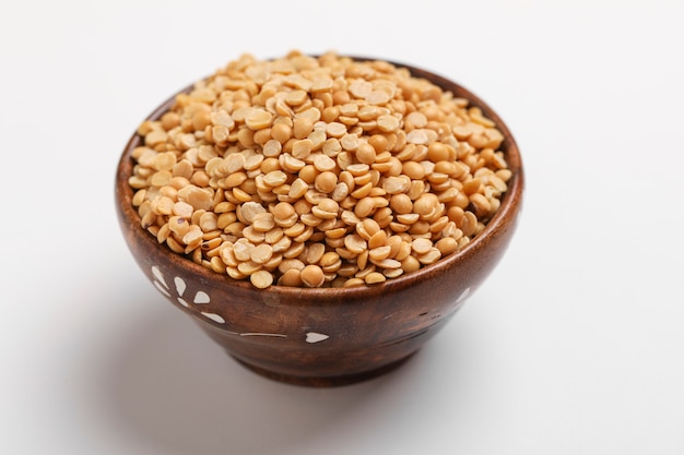 Pigeon pea also known as toor dal in wooden bowl.