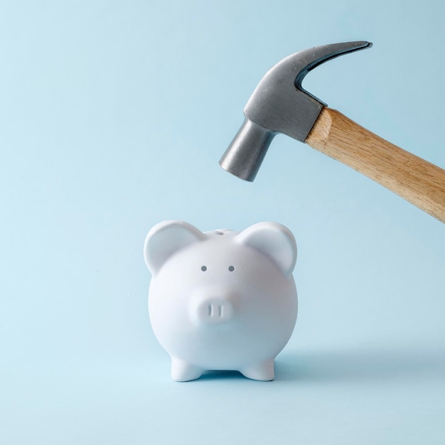 The piggy bank as a symbol of savings and income will hit the hammer