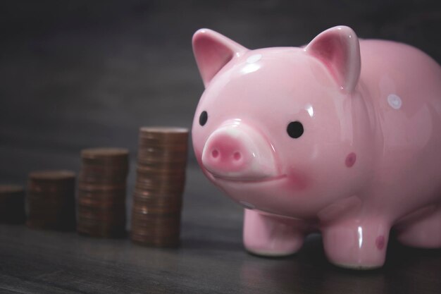 Piggy bank and coins on the table in the form of a graph