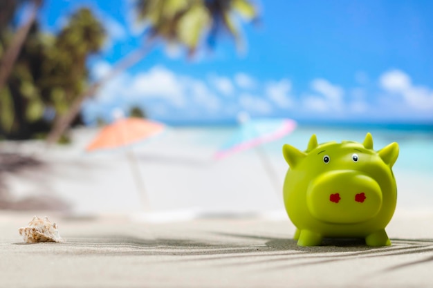 Photo piggy bank on sunny beach savings for vacation concept