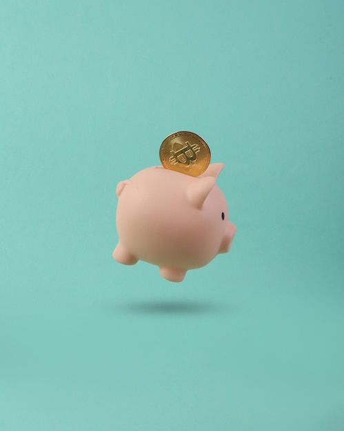 Piggy bank with bitcoin floating on blue background 3D photo Concept art Minimalism