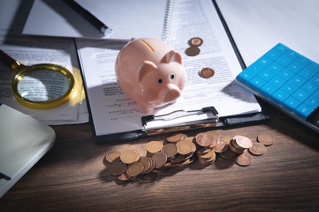 Piggy bank with coins on the business desk