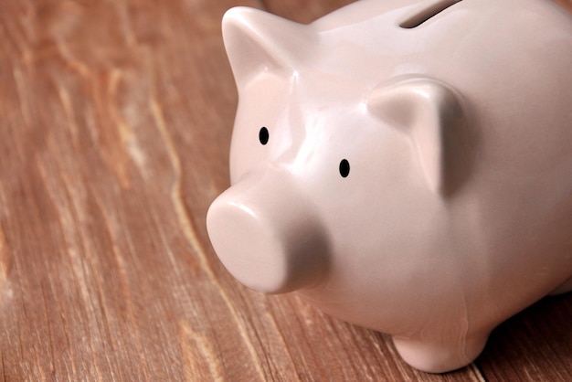 Piggy bank on a wooden background a symbol of money accumulation